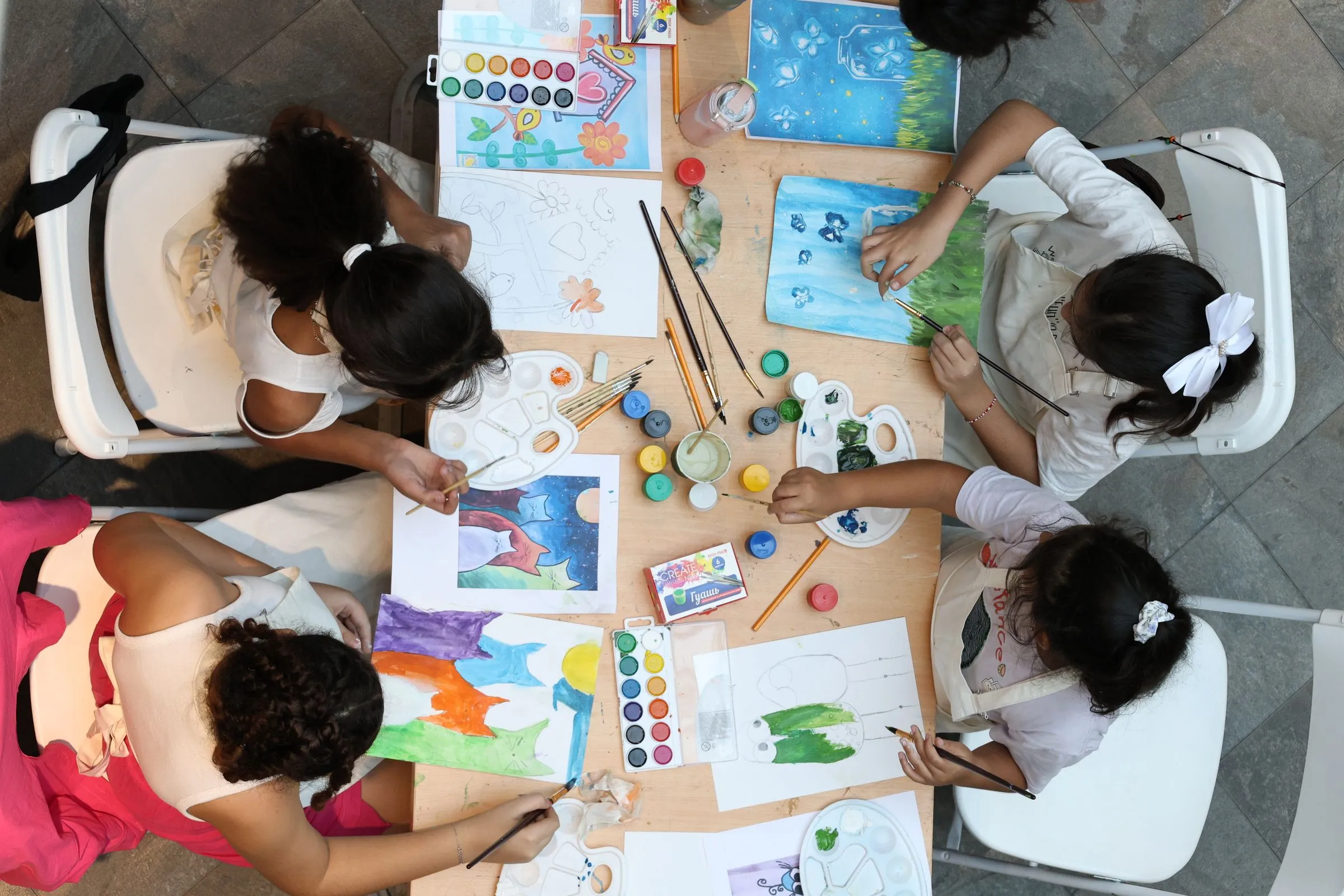 Children painting at the art table